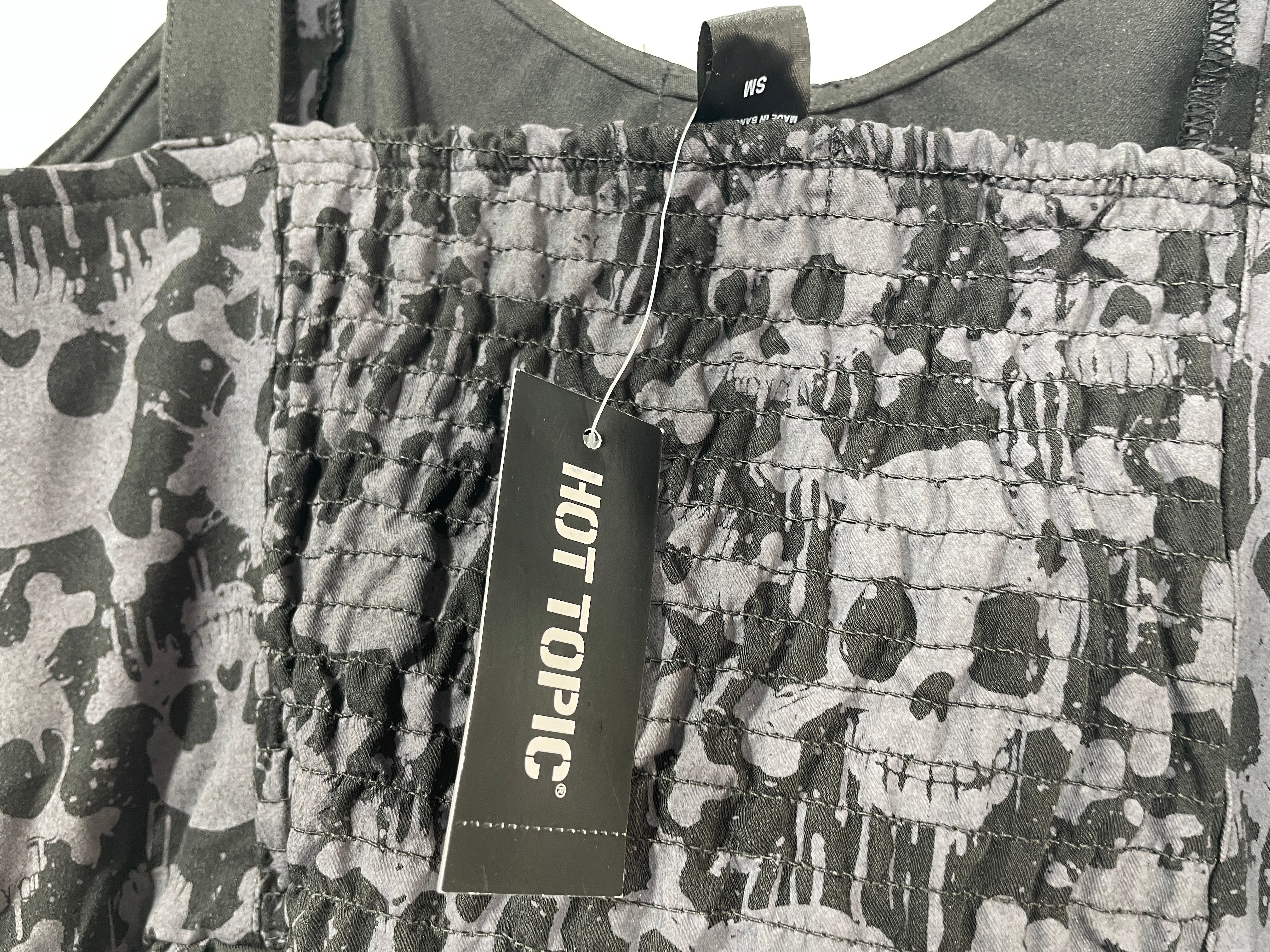 Camouflage-patterned pants with a 'Hot Topic' tag on a white background