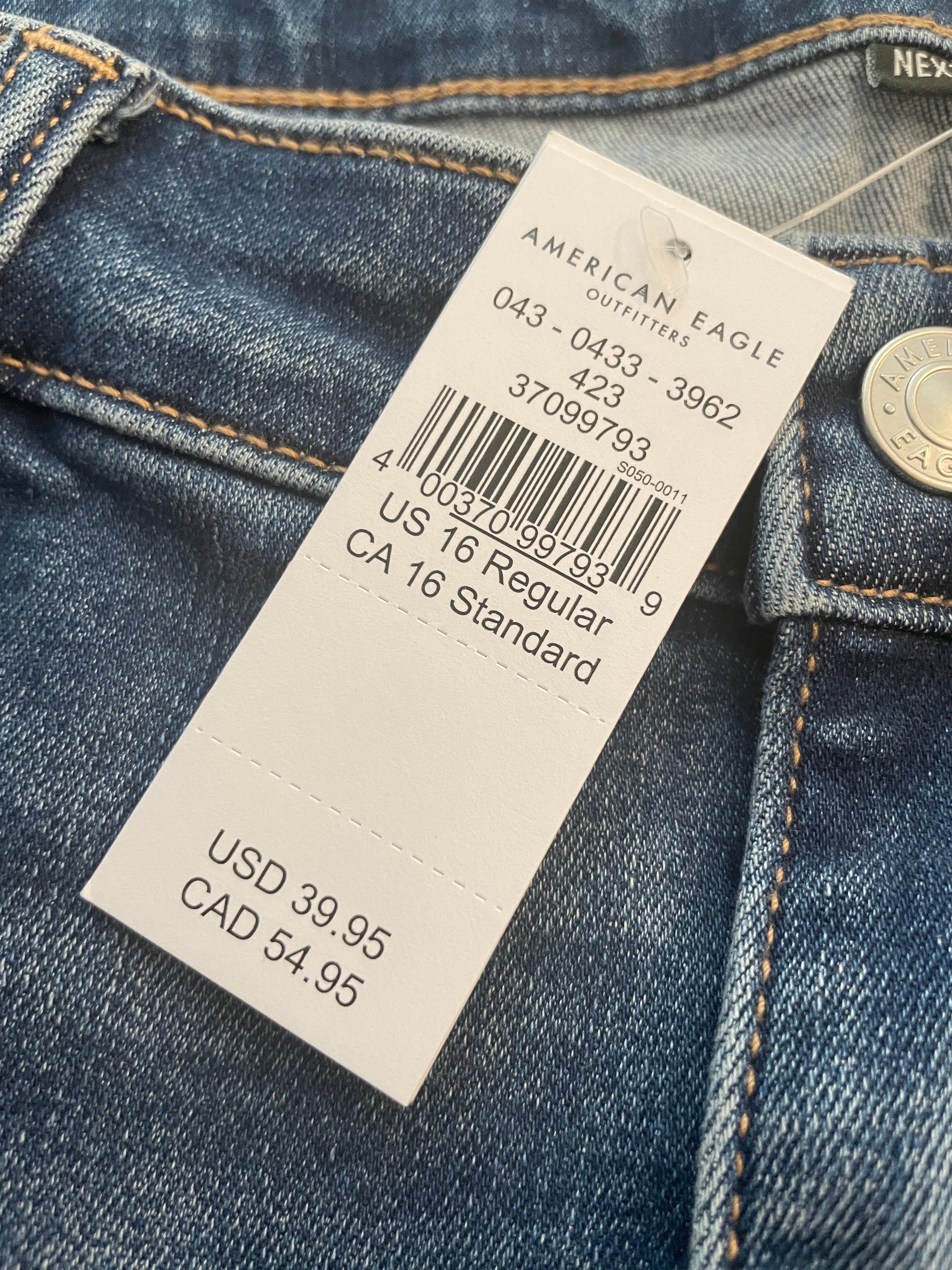 Close-up of a jeans tag with brand and size information.