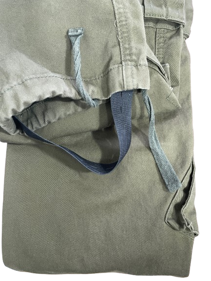 Detail of the leg hem showing drawstring and elastic boot stirrup.