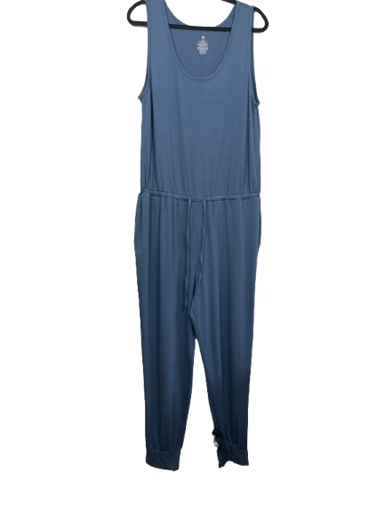 A slate blue sleeveless jumpsuit hanging on a black hanger against a plain white background.