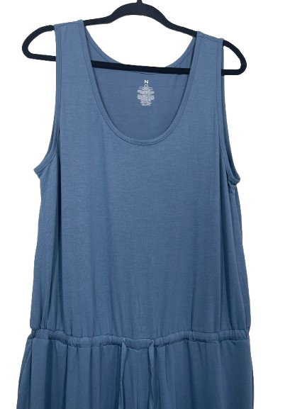 A sleeveless scoop-neck dress in dusty blue, hanging on a black hanger against a plain white background.