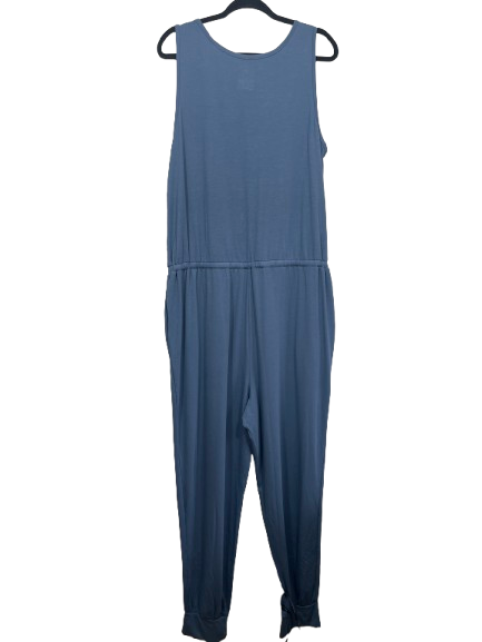 A slate blue sleeveless jumpsuit hanging on a black hanger against a plain white background.