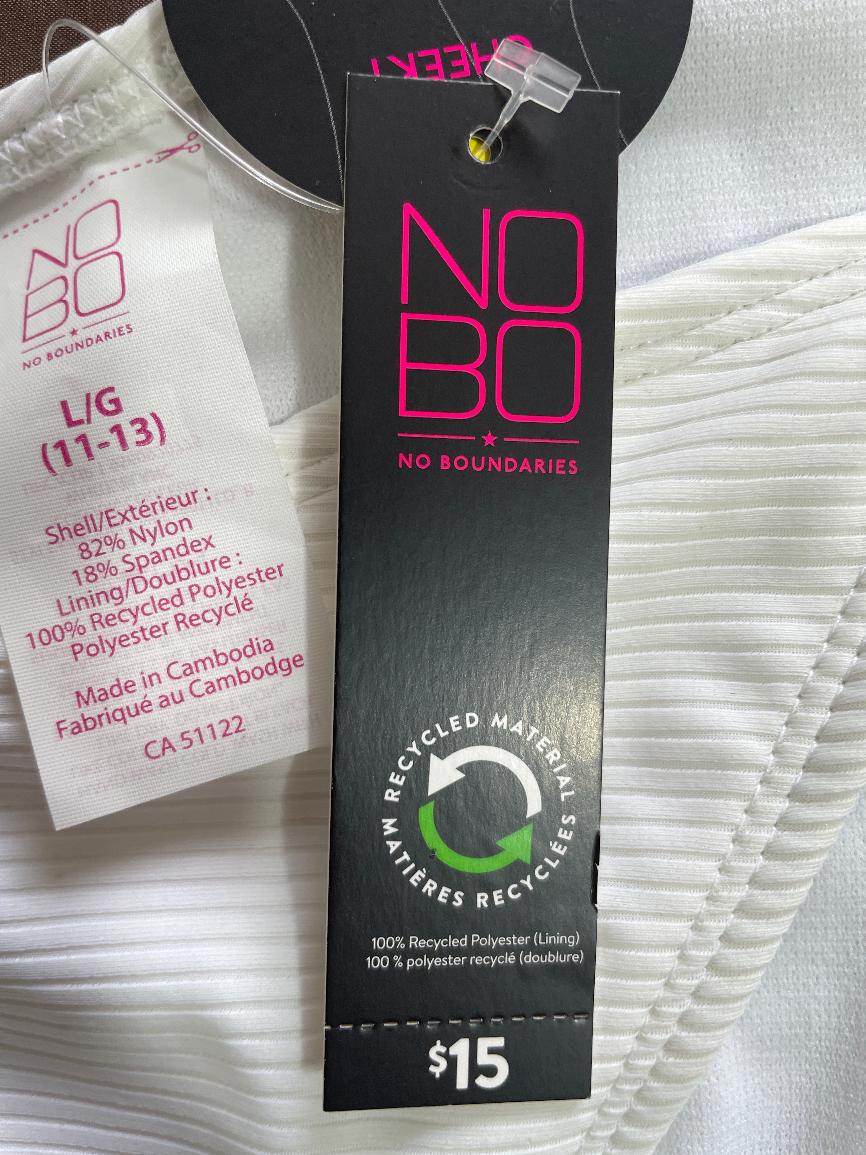 Close-up of a white ribbed garment tag and price tag from NO BO NO, showing recycled material branding and product details.
