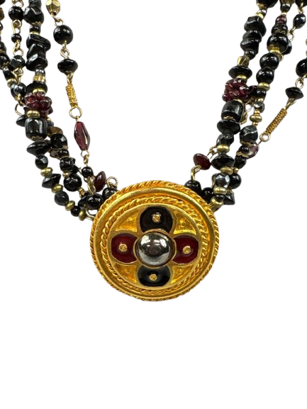 Close-up of vintage necklace with large gold medallion pendant