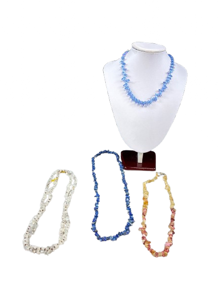 Lot of four gemstone necklaces displayed on stand