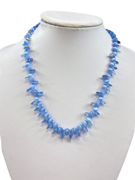Close-up of light blue cat’s eye necklace with silver clasp