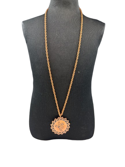 Copper bird pendant necklace on display stand